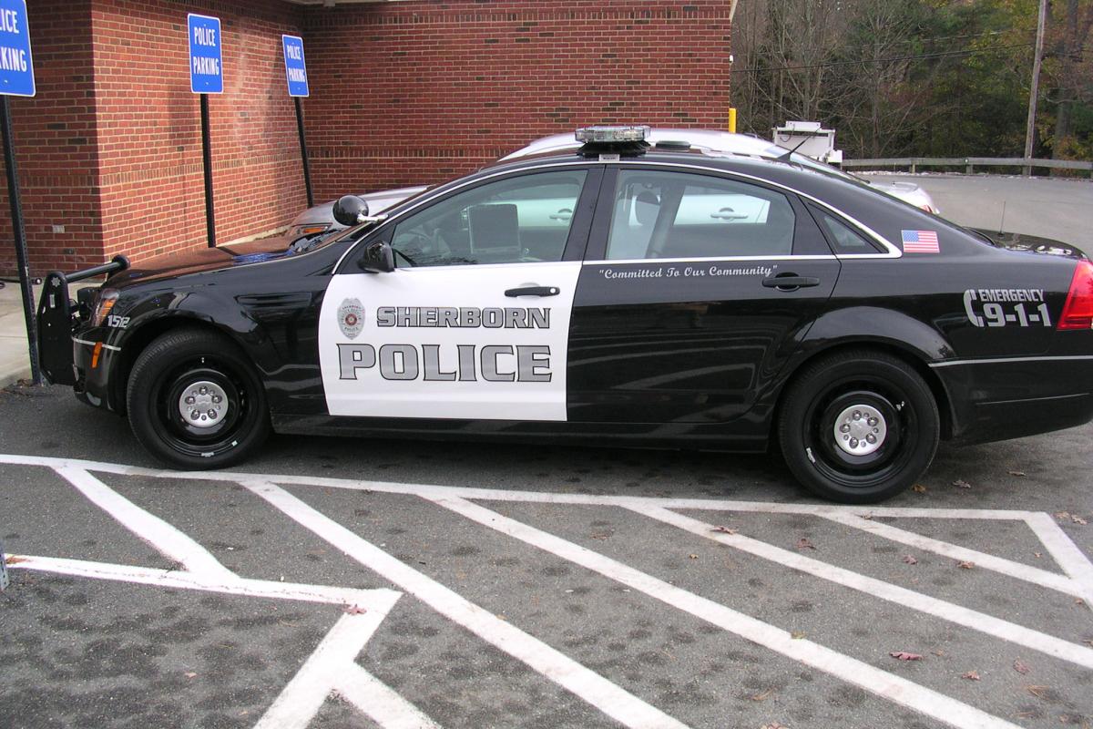 A Sherborn Police car parked in a designated spot