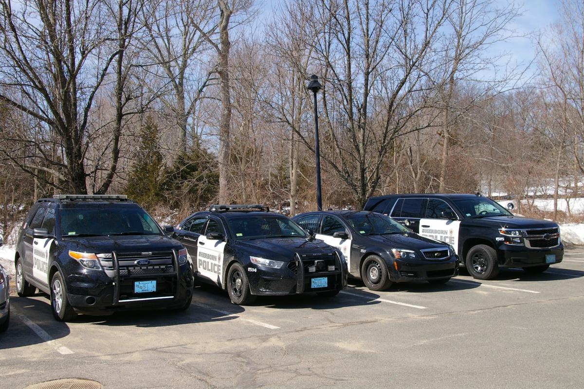 Four different police cruisers parked in a row