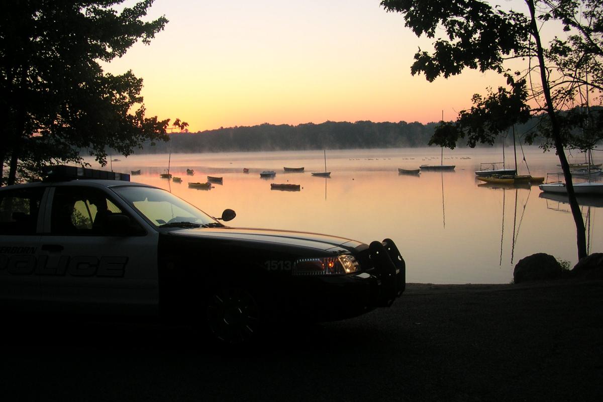 Police cruiser in front of a lake